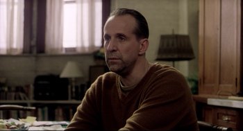 Movie still from “Birth” (2004), directed by Jonathan Glazer – A person sitting at a table; Close Up shot, Over the shoulder angle