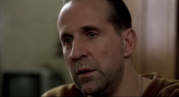 Movie still from “Birth” (2004), directed by Jonathan Glazer – A person looking at the camera; Close Up shot, Over the shoulder angle