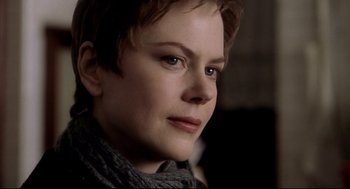 Movie still from “Birth” (2004), directed by Jonathan Glazer – A person with short brown hair; Close Up shot, Over the shoulder angle
