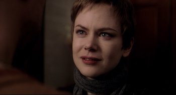Movie still from “Birth” (2004), directed by Jonathan Glazer – A person with short hair; Close Up shot, Over the shoulder angle