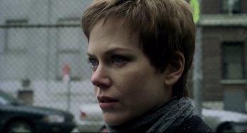 Movie still from “Birth” (2004), directed by Jonathan Glazer – A person with short brown hair; Close Up shot, Over the shoulder angle