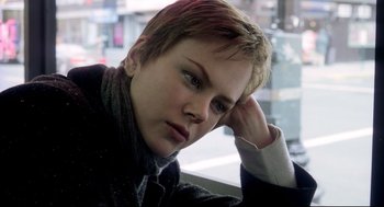 Movie still from “Birth” (2004), directed by Jonathan Glazer – A young woman sitting in front of a window; Close Up shot, Over the shoulder angle