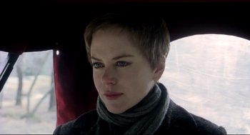 Movie still from “Birth” (2004), directed by Jonathan Glazer – A person with short hair; Close Up shot, Over the shoulder angle