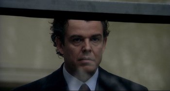 Movie still from “Birth” (2004), directed by Jonathan Glazer – A person wearing a suit and tie; Close Up shot, Over the shoulder angle