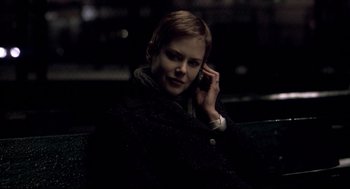Movie still from “Birth” (2004), directed by Jonathan Glazer – A woman sitting down talking on a cell phone; Close Up shot, Over the shoulder angle