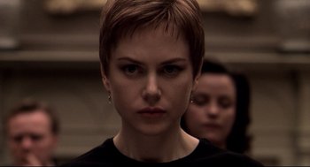 Movie still from “Birth” (2004), directed by Jonathan Glazer – A person with short brown hair; Close Up shot, Over the shoulder angle