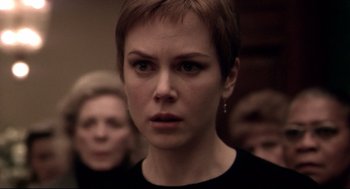 Movie still from “Birth” (2004), directed by Jonathan Glazer – A person with short brown hair; Close Up shot, Over the shoulder angle