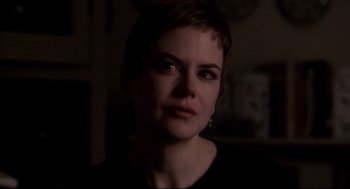 Movie still from “Birth” (2004), directed by Jonathan Glazer – A person with short brown hair; Close Up shot, Over the shoulder angle
