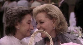 Movie still from “Birth” (2004), directed by Jonathan Glazer – Two older women are kissing each other's face; Close Up shot, Over the shoulder angle