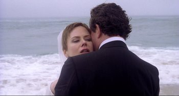 Movie still from “Birth” (2004), directed by Jonathan Glazer – A man and a woman kissing on the beach; Close Up shot, Over the shoulder angle