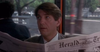 Movie still from “Bitter Moon” (1992), directed by Roman Polanski – A man sitting in front of a window reading a newspaper; Close Up shot, Over the shoulder angle