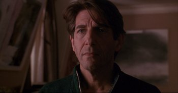 Movie still from “Bitter Moon” (1992), directed by Roman Polanski – A person wearing a green sweater; Close Up shot, Over the shoulder angle