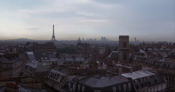 Movie still from “Bitter Moon” (1992), directed by Roman Polanski – A view of the eiffel tower from the top of a building; Extreme Wide shot, Low angle