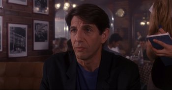 Movie still from “Bitter Moon” (1992), directed by Roman Polanski – A person sitting in a room; Close Up shot, Over the shoulder angle