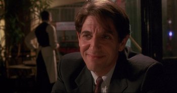 Movie still from “Bitter Moon” (1992), directed by Roman Polanski – A person wearing a suit and tie; Close Up shot, Over the shoulder angle