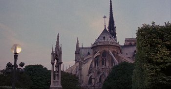 Movie still from “Bitter Moon” (1992), directed by Roman Polanski – A large cathedral with a cross on top of it's roof; Extreme Wide shot, Low angle