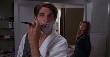 Movie still from “Bitter Moon” (1992), directed by Roman Polanski – A man shaving his face in front of a mirror; Close Up shot, Over the shoulder angle
