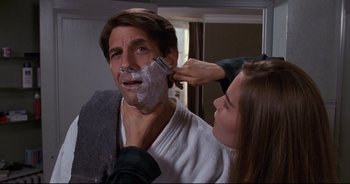 Movie still from “Bitter Moon” (1992), directed by Roman Polanski – A woman shaving a man's face in a bathroom; Close Up shot, Over the shoulder angle