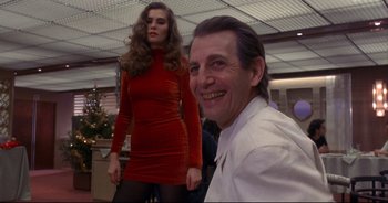 Movie still from “Bitter Moon” (1992), directed by Roman Polanski – A man and a woman posing for a picture; Medium shot, Low angle