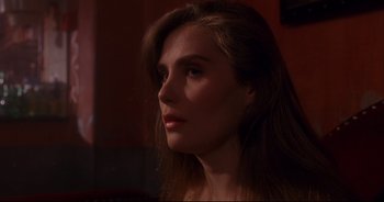 Movie still from “Bitter Moon” (1992), directed by Roman Polanski – A beautiful young woman with long brown hair; Close Up shot, Over the shoulder angle