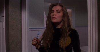Movie still from “Bitter Moon” (1992), directed by Roman Polanski – A woman holding a toothbrush in her hand; Close Up shot, Over the shoulder angle