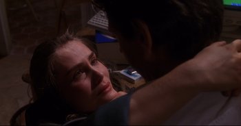 Movie still from “Bitter Moon” (1992), directed by Roman Polanski – A man and a woman sitting on a couch; Close Up shot, Over the shoulder angle