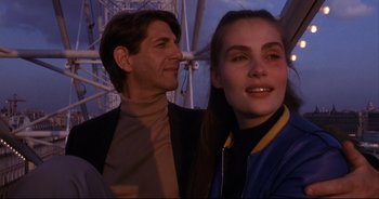 Movie still from “Bitter Moon” (1992), directed by Roman Polanski – A man and a woman standing next to each other under an umbrella; Close Up shot, Low angle