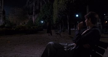 Movie still from “Bitter Moon” (1992), directed by Roman Polanski – Two people walking in a park at night; Wide shot, Over the shoulder angle