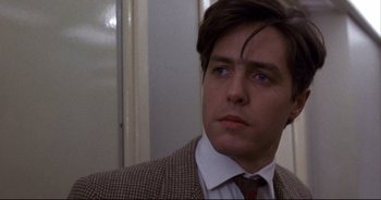 Movie still from “Bitter Moon” (1992), directed by Roman Polanski – A person wearing a suit and tie; Close Up shot, Low angle