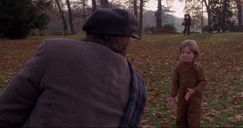 Movie still from “Bitter Moon” (1992), directed by Roman Polanski – A man and a child in a field; Medium shot, Over the shoulder angle