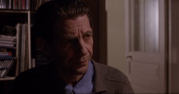 Movie still from “Bitter Moon” (1992), directed by Roman Polanski – A person wearing a jacket; Close Up shot, Over the shoulder angle