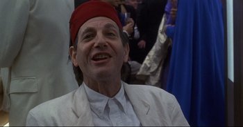 Movie still from “Bitter Moon” (1992), directed by Roman Polanski – A person wearing a red hat; Close Up shot, Over the shoulder angle