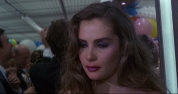 Movie still from “Bitter Moon” (1992), directed by Roman Polanski – A person with long brown hair; Close Up shot, Over the shoulder angle