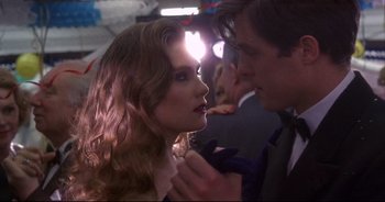 Movie still from “Bitter Moon” (1992), directed by Roman Polanski – A man and a woman in formal wear looking at one another; Close Up shot, Over the shoulder angle