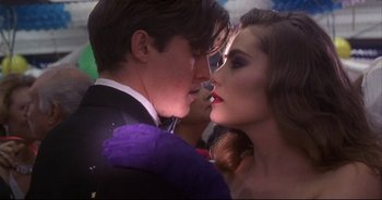 Movie still from “Bitter Moon” (1992), directed by Roman Polanski – A man and a woman are kissing each other; Close Up shot, Over the shoulder angle