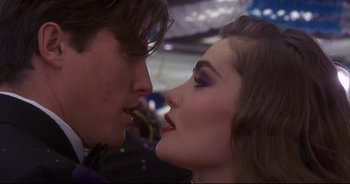 Movie still from “Bitter Moon” (1992), directed by Roman Polanski – A person kissing another person's face; Close Up shot, Over the shoulder angle