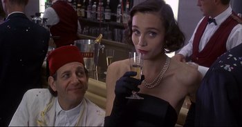 Movie still from “Bitter Moon” (1992), directed by Roman Polanski – A man and a woman drinking champagne at a bar; Medium shot, Over the shoulder angle