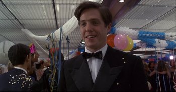 Movie still from “Bitter Moon” (1992), directed by Roman Polanski – A man in a tuxedo standing next to balloons in a room; Close Up shot, Low angle