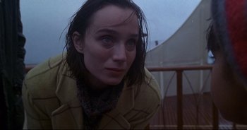 Movie still from “Bitter Moon” (1992), directed by Roman Polanski – A woman with wet hair sitting on the ground; Close Up shot, Low angle