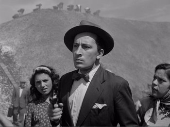 Movie still from “Bitter Rice” (1949), directed by Giuseppe De Santis – A black and white photo of a man and a woman; Medium shot, Low angle