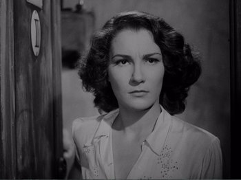 Movie still from “Bitter Rice” (1949), directed by Giuseppe De Santis – An old black and white photo of a woman; Close Up shot, High angle