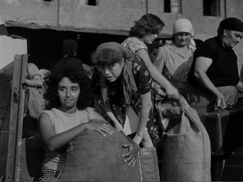 Movie still from “Bitter Rice” (1949), directed by Giuseppe De Santis – A black and white photo of a group of women; Medium shot, High angle