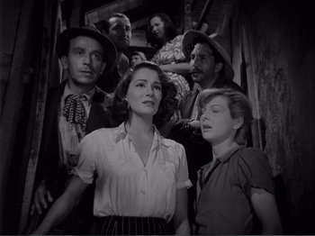 Movie still from “Bitter Rice” (1949), directed by Giuseppe De Santis – A black and white photo of a group of people; Medium shot, Low angle