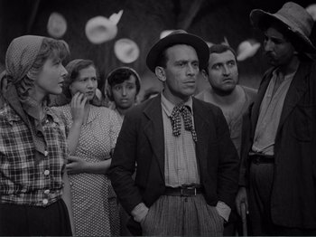 Movie still from “Bitter Rice” (1949), directed by Giuseppe De Santis – A group of men and women standing together; Medium shot, Low angle