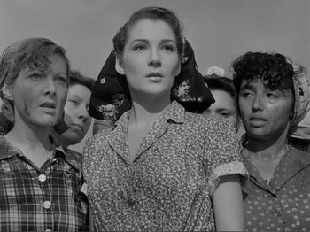 Movie still from “Bitter Rice” (1949), directed by Giuseppe De Santis – A group of women standing next to each other; Medium shot, Low angle