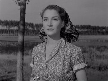 Movie still from “Bitter Rice” (1949), directed by Giuseppe De Santis – An old photo of a woman in a field; Close Up shot, Low angle