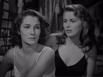 Movie still from “Bitter Rice” (1949), directed by Giuseppe De Santis – Two beautiful young women sitting next to each other; Close Up shot, Over the shoulder angle