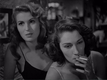Movie still from “Bitter Rice” (1949), directed by Giuseppe De Santis – Two beautiful women sitting next to each other smoking; Close Up shot, Low angle