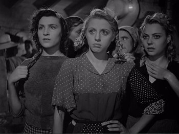 Movie still from “Bitter Rice” (1949), directed by Giuseppe De Santis – A black and white photo of a group of women; Medium shot, Low angle
