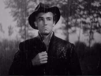 Movie still from “Bitter Rice” (1949), directed by Giuseppe De Santis – A black and white photo of a man wearing a hat; Close Up shot, Low angle